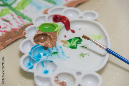 Color paint tray and brush close-up background material for painting industry
