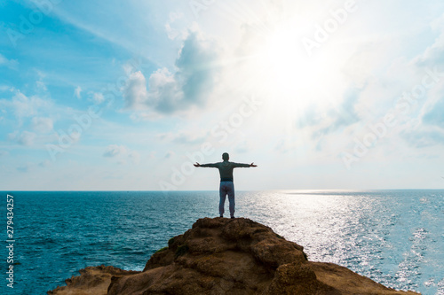 Fototapeta Man rise hands up to sky freedom concept with blue sky and summer beach background