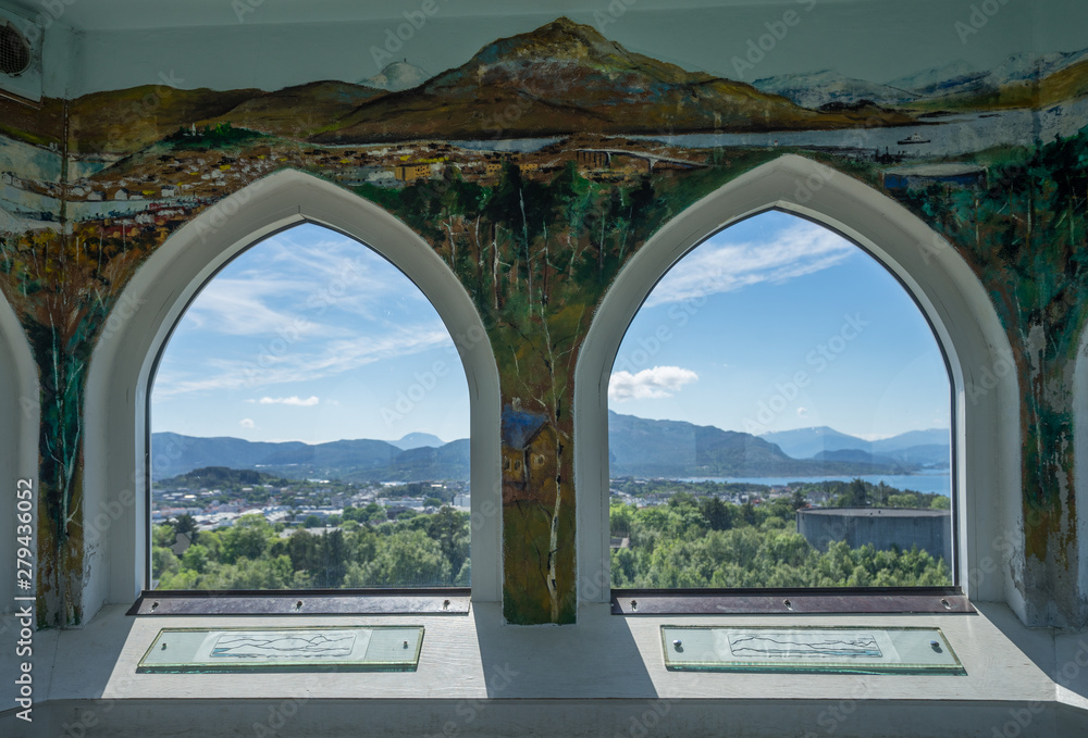 Kristiansund / Norway - June 15 2019: Interior of the Varden viewpoint, the highest point on Kirkelandet. Decorated wall inside, 360 degrees view via arched windows on surrounding mountains and fjord.