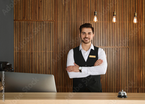 Portrait of receptionist at desk in lobby