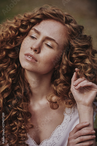 Beautiful curly girl in white lingerie. Outdoor photography