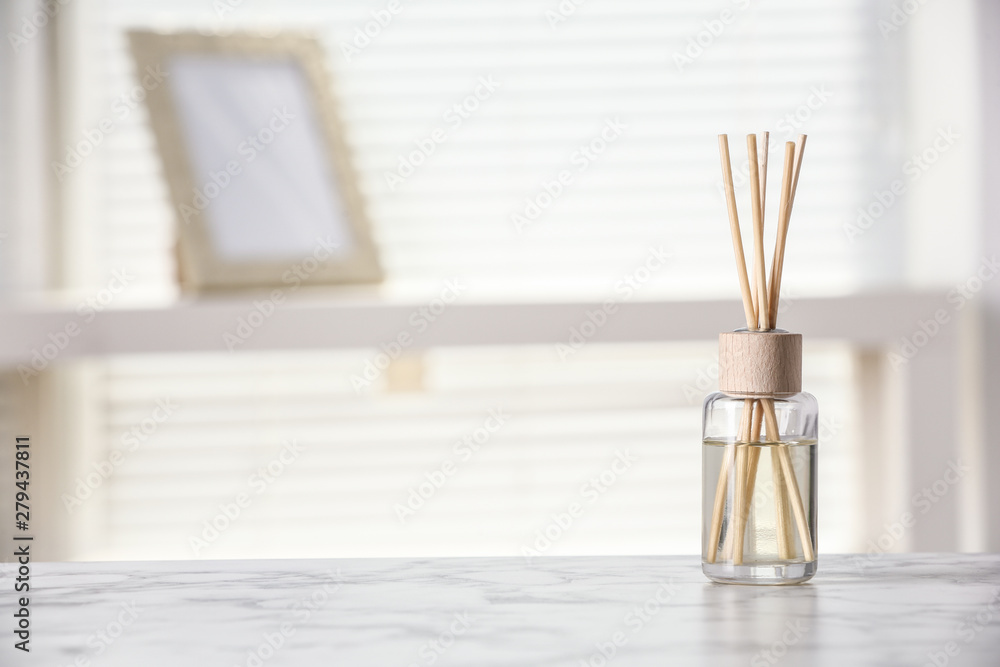 Aromatic reed air freshener on white table at home, space for text Aromatic reed air freshener on white table at home, space for text