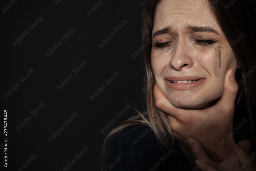Man abusing young woman on dark background, space for text. Stop sexual assault Man abusing young woman on dark background, space for text. Stop sexual assault
