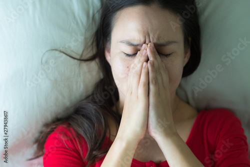 Fotografie Stressed sad woman covering her face.
