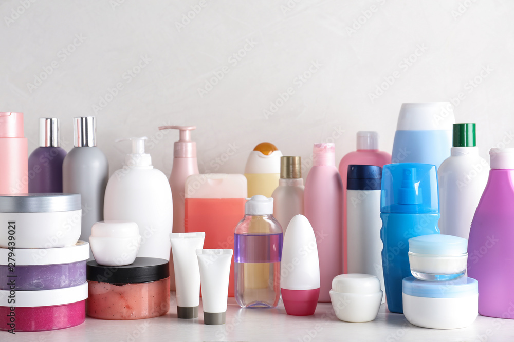 Different body care products on table against light background Different body care products on table against light background