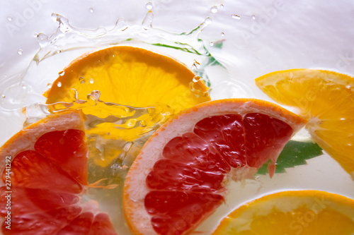 Fresh orange and grapefruit in water