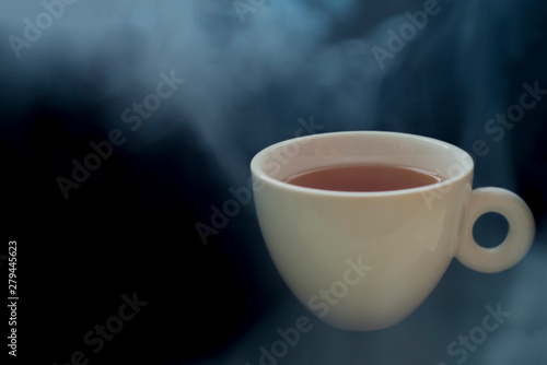 Hot drinks with smoke on the black background scene