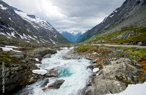 Norwegian landscape with mountains  streaming rivers and waterfalls. 100-year-old national tourist route  The Old Stryn Mountain Road   country road 258  close to summer ski center.