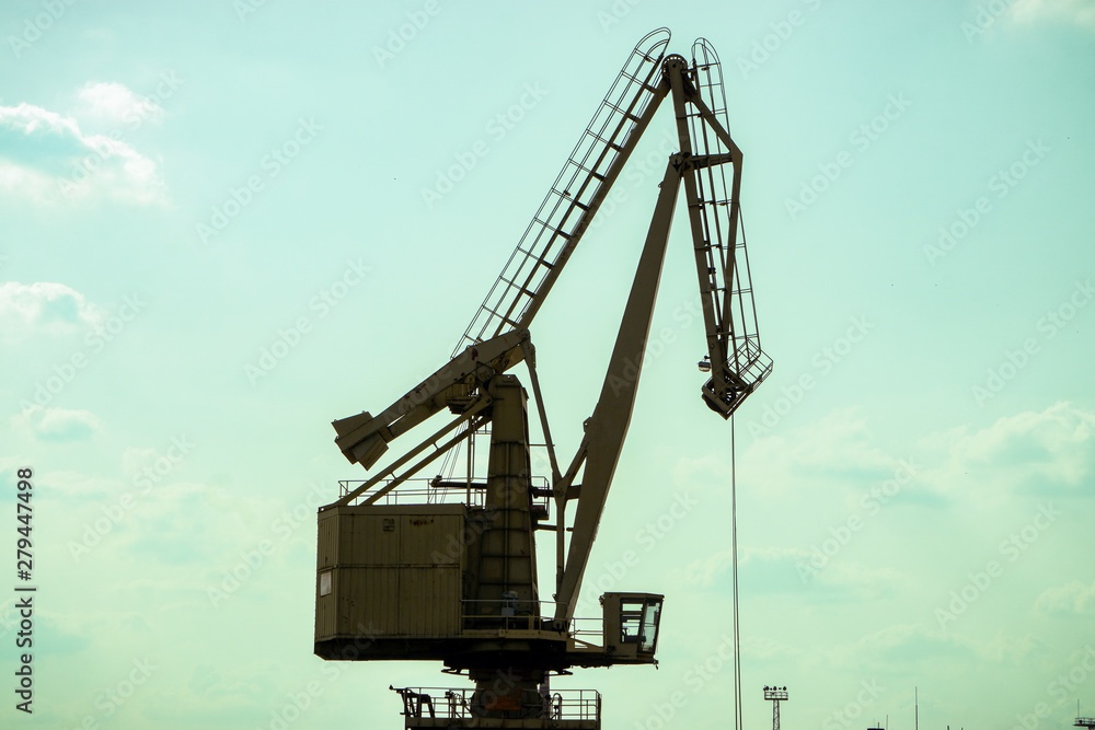 Crane in the seaport for coal loading. Crane in the seaport for coal loading.