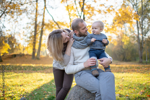 Happy family couple with child sincere emotions outdoor portrait. © benevolente