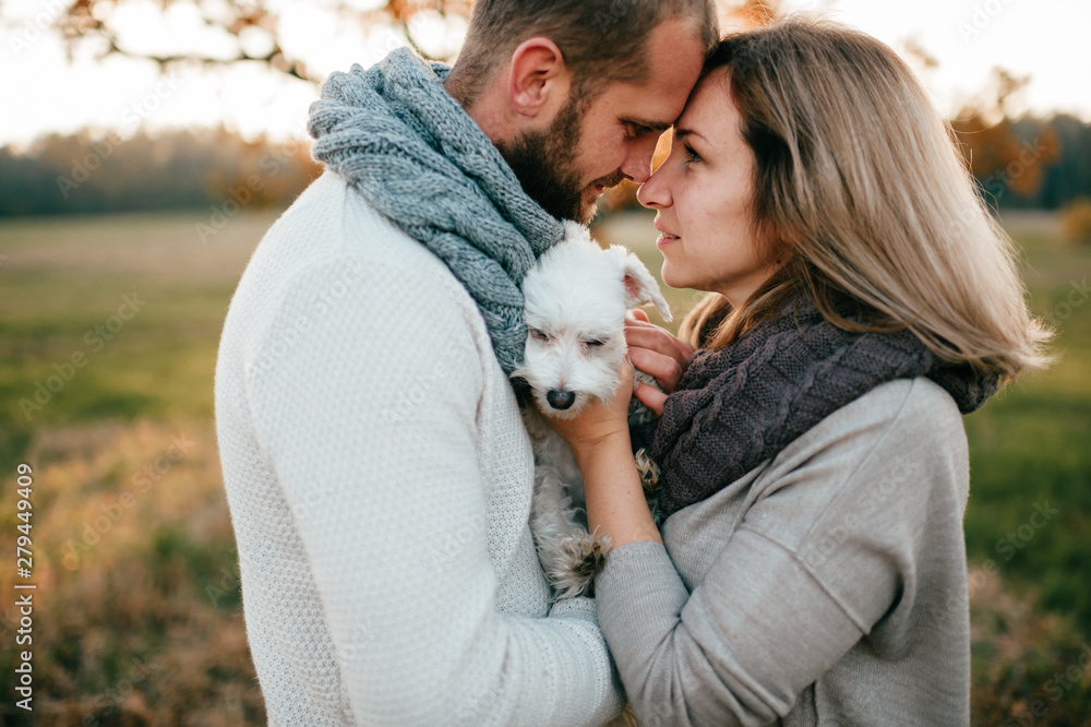 Loving couple with funny pet romantic portrait at nature. Loving couple with funny pet romantic portrait at nature.