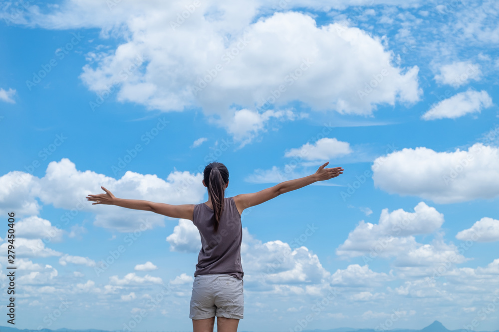 lifestyle concept - beautiful happy woman enjoying summer outdoors over blue sky lifestyle concept - beautiful happy woman enjoying summer outdoors over blue sky
