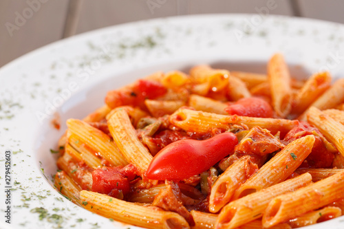 Plate of pasta with tomato , Italian healthy food , wood background.