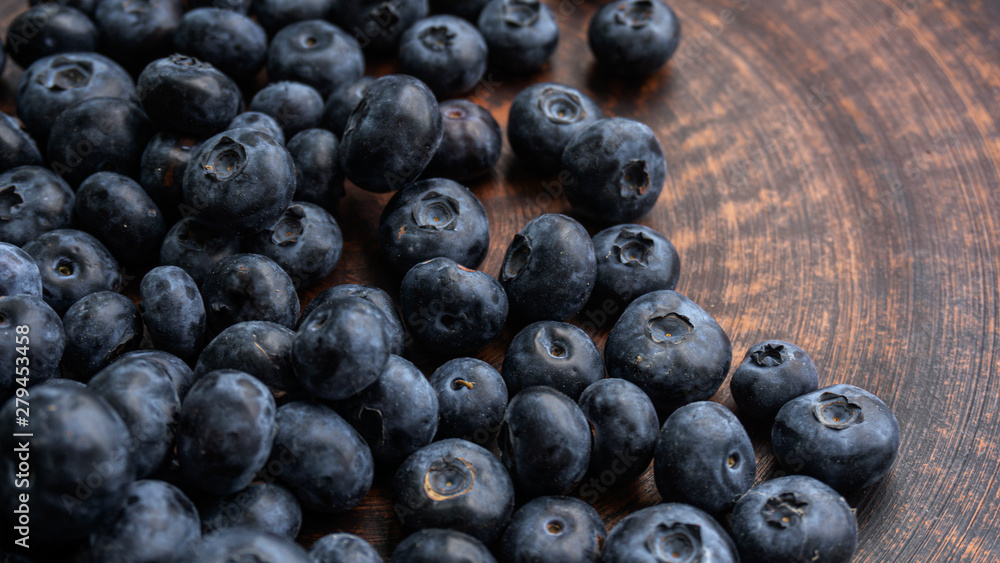Blueberries and blueberries on the background of pottery. Black berries. Blueberries and blueberries on the background of pottery. Black berries.
