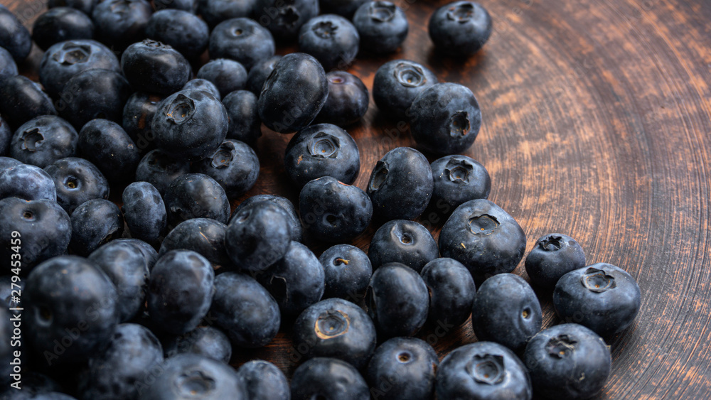 Blueberries and blueberries on the background of pottery. Black berries. Blueberries and blueberries on the background of pottery. Black berries.
