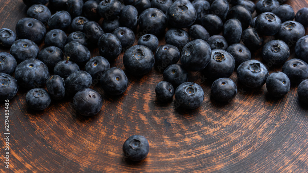 Blueberries and blueberries on the background of pottery. Black berries. Blueberries and blueberries on the background of pottery. Black berries.