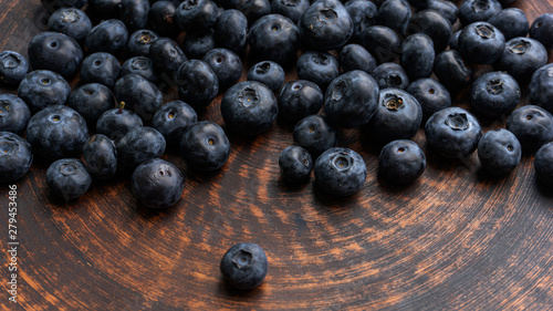 Blueberries and blueberries on the background of pottery. Black berries.