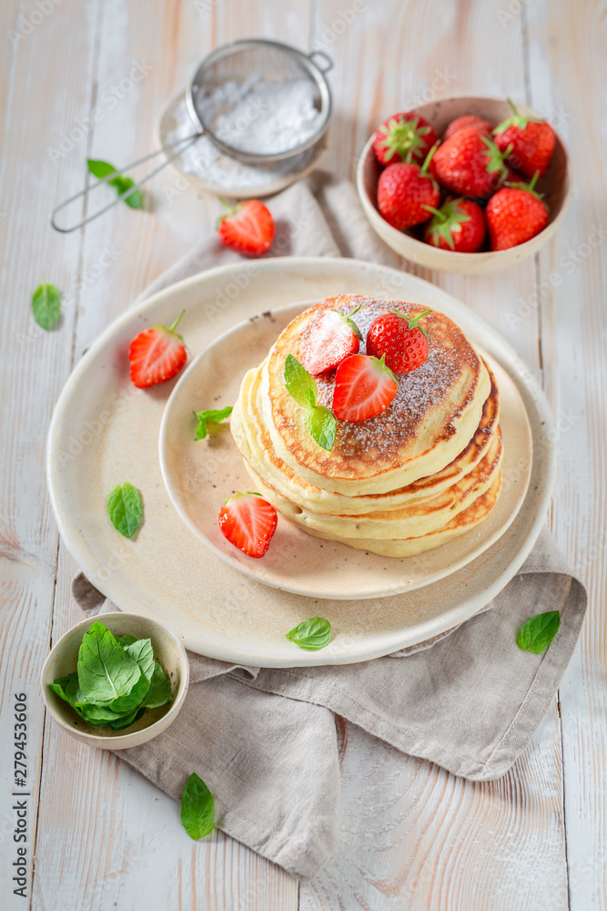 Delicious american pancakes with fresh sweet strawberries and sugar Delicious american pancakes with fresh sweet strawberries and sugar