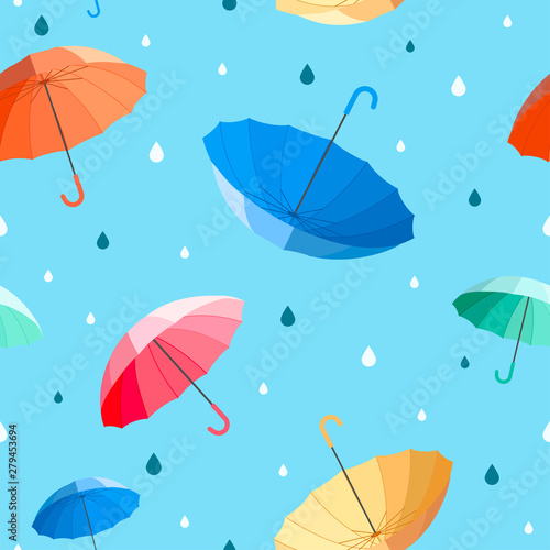 Umbrellas seamless pattern vector illustration. colorful umbrellas with raindrops on blue background.