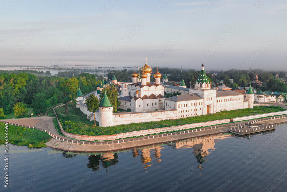 Scenic aerial view of famous Ipatievsky (Hypatian) Monastery in ancient touristic town Kostroma in Russia. Beautiful look of old russian orthodox monastery with gold-plated domes in morning light