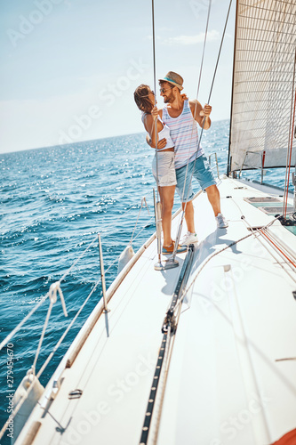 Happy man and woman on the luxury yacht enjoying together.