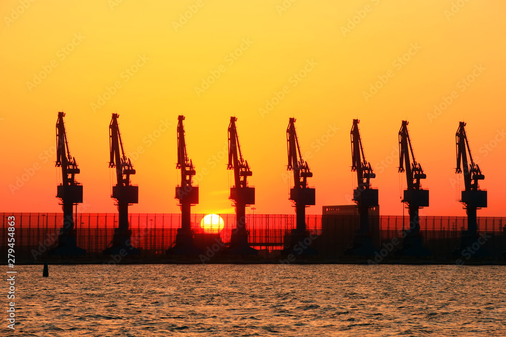 Cranes at the cargo terminal in the evening Cranes at the cargo terminal in the evening