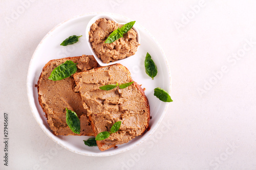Chicken liver pate over bread slices