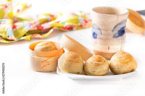 Oriental food concept homemade organic Huaiyang Spiral Chinese flaky  pastry moon cake on white background with copy space photo