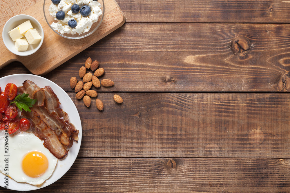 Ketogenic food: nuts, cream, bacon, berries.  Top view