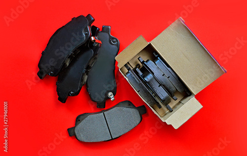 Car brake pads on a red background. Unboxing. photo