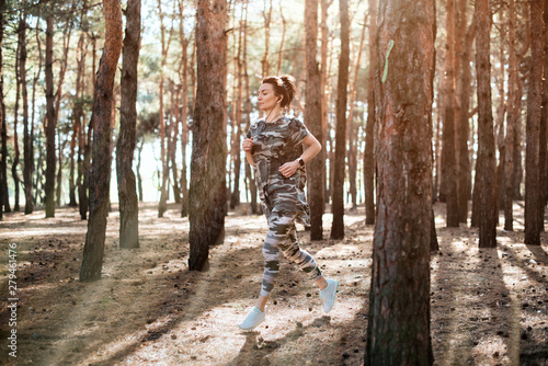 woman jogging in forest in the morning © VlaDee