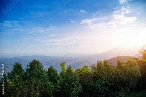 Mountains view landscape forest with rising sun and fog in the morning. Beautiful scenery view in countryside of asia.