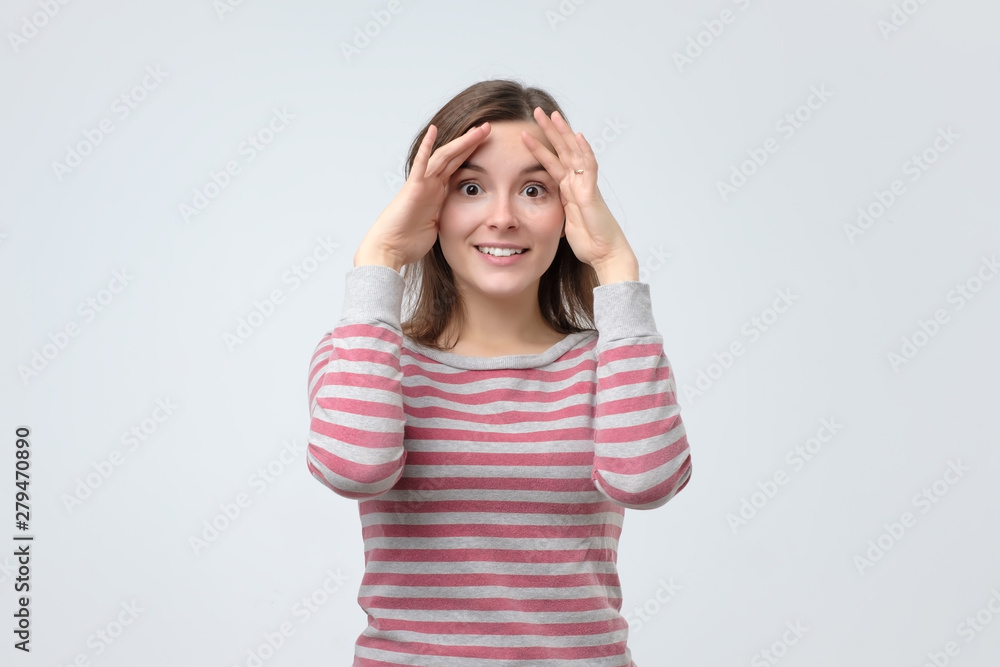 Young woman smiling and playing peekaboo. Wow it is a great surprise for birthday. Young woman smiling and playing peekaboo. Wow it is a great surprise for birthday.