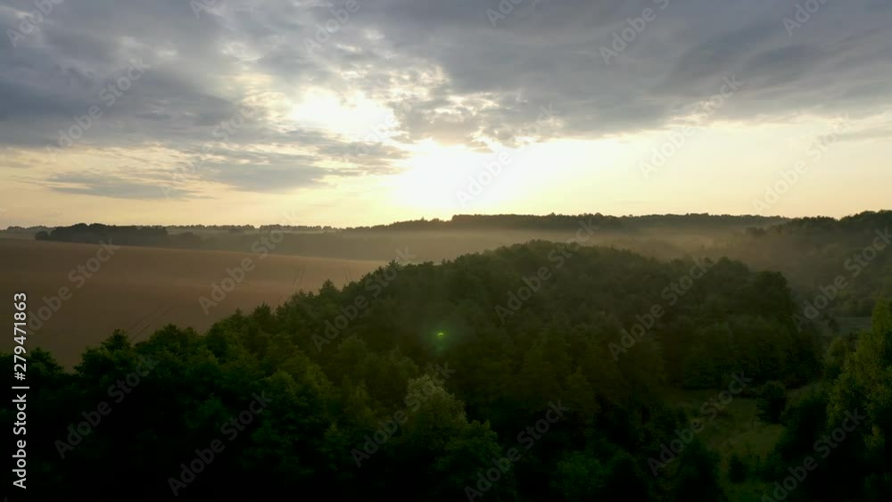 Aerial view, flying over the morning meadow, in the mist at dawn. Aerial view, flying over the morning meadow, in the mist at dawn.