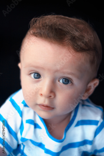 Adorable cute colorful eyed baby portrait. Curious baby boy posing camera.