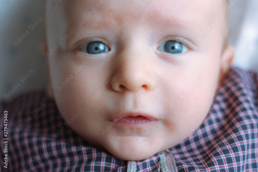 Adorable cute colorful eyed baby portrait. Curious baby boy posing camera.