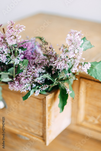  Bright and stylish interior details. Decor in the photo Studio of a bouquet of lilacs.