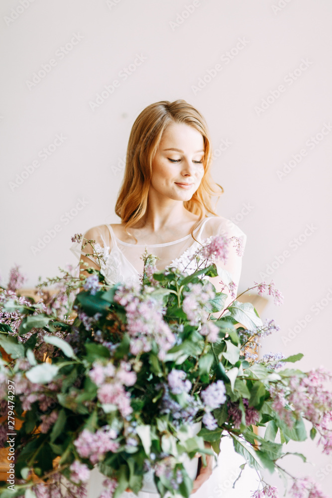 Wedding in European style. Stylish trendy bride in the Studio with a bouquet of lilacs. Wedding in European style. Stylish trendy bride in the Studio with a bouquet of lilacs.