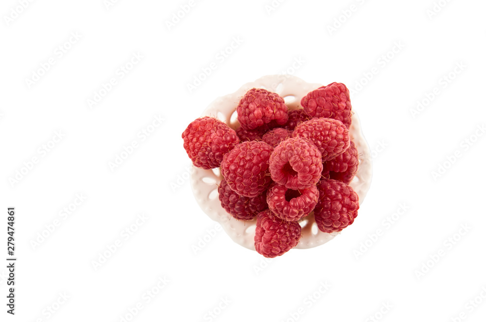 Red raspberry berries on a saucer isolated on a white background. The view from the top. Red raspberry berries on a saucer isolated on a white background. The view from the top.