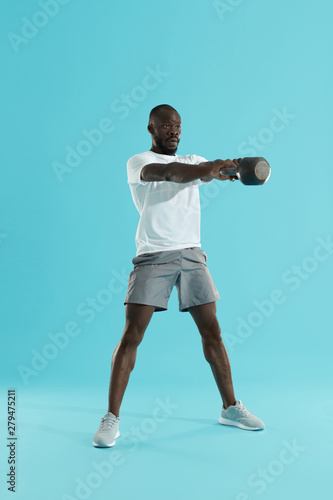 Fototapeta Naklejka Na Ścianę i Meble -  Workout. Man doing kettlebell swing exercise, sports training