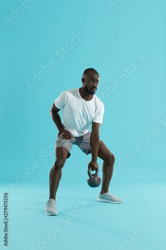 Workout. Sports man doing kettlebell exercise training
