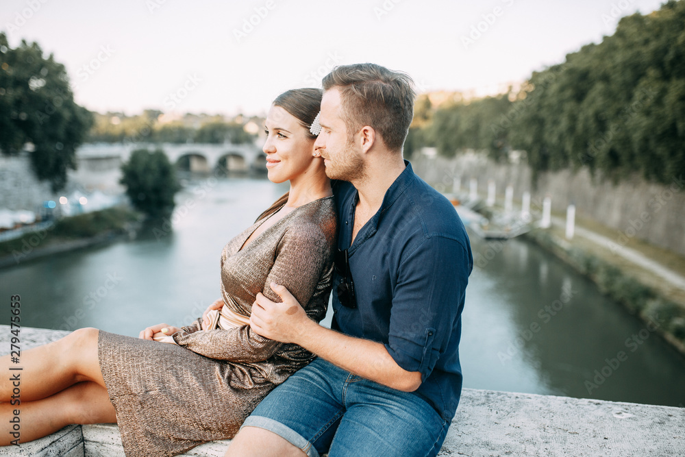 Happy couple at sunset in Italy. Evening summer photo shoot in Rome.