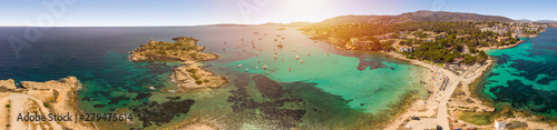 Panoramic seascape. People rest on the beach, yachts in the bay. Summertime. Playa de Illetas beach, Palma de Mallorca, Balearic Islands