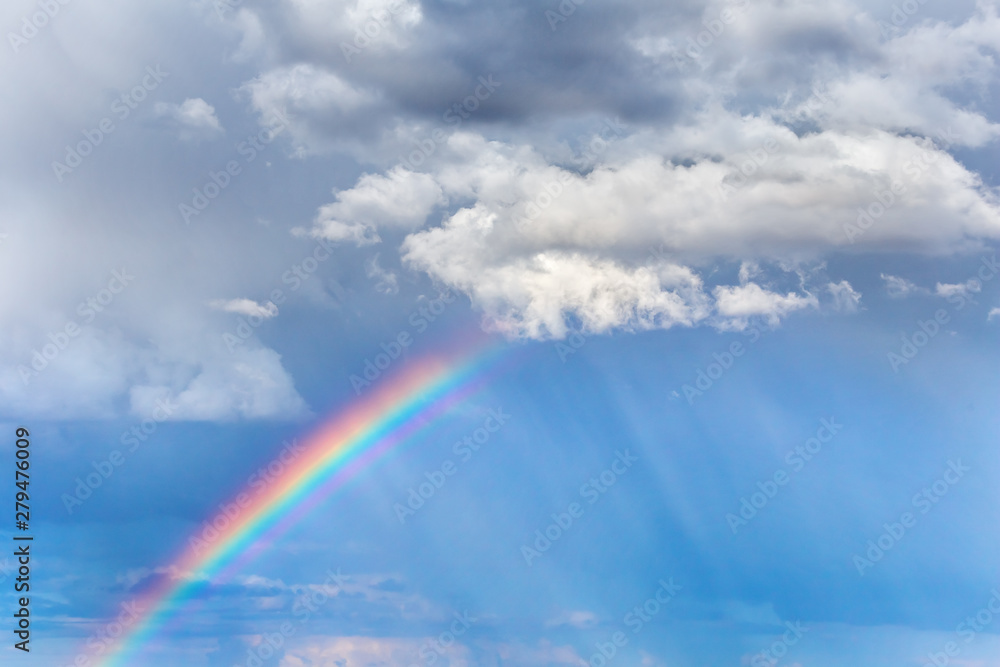 Natural rainbow and clouds in the sky. Bright, colorful background art design. Natural rainbow and clouds in the sky. Bright, colorful background art design.