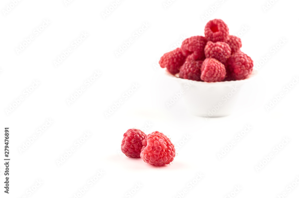Red raspberry berries on a saucer isolated on a white background. Red raspberry berries on a saucer isolated on a white background.