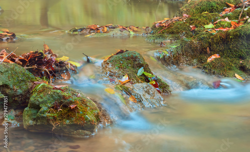 Fototapeta Naklejka Na Ścianę i Meble -  closeup small creek rushind among the stones