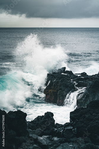 Azores, Big waves crashing over black volcanic rock on the Atlantic Ocean in the coast of Sao Miguel island in the Azores, Portugal