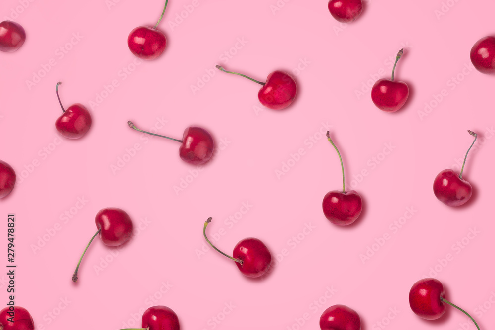 Cherry pattern. Flat lay of cherries on a pink background. Top view Cherry pattern. Flat lay of cherries on a pink background. Top view