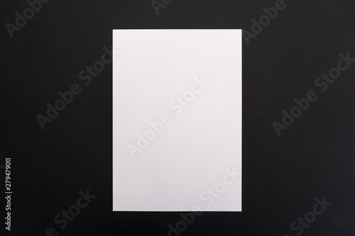 Blank white paper sheet on black background. Layout for business, posters and banners.
