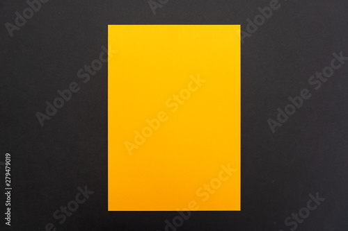Blank orange paper sheet on black background. Layout for business, posters and banners.